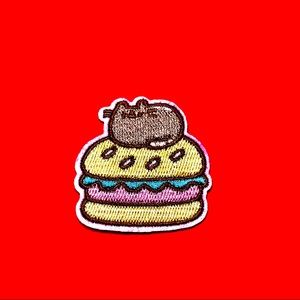 Pusheen cat sitting on a sandwich iron on patch